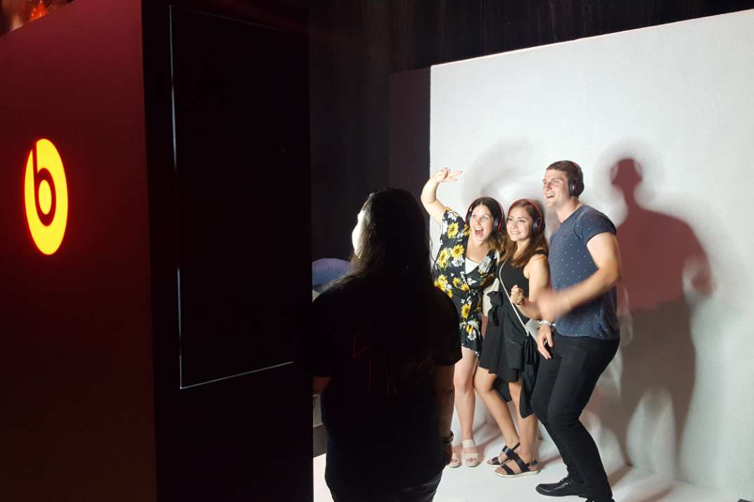 People posing in front of photo booth